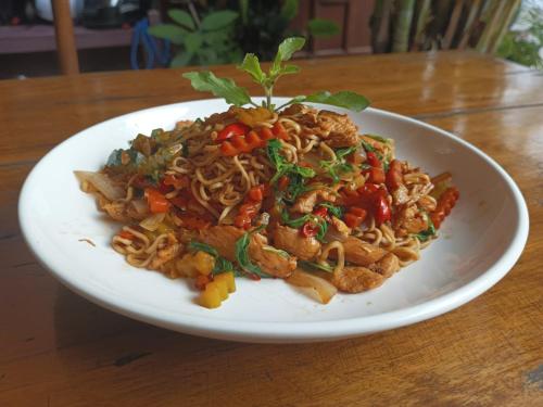 a plate of food with noodles and vegetables on a table at Song Lao Guesthouse in Thakhek