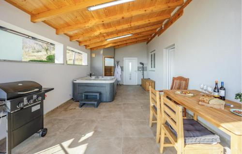 a kitchen and dining room with a table and a stove at Beautiful Home In Jastrebarsko in Jastrebarsko