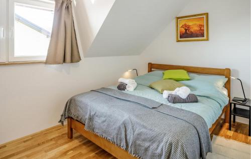 a bedroom with a bed with two stuffed animals on it at Beautiful Home In Jastrebarsko in Jastrebarsko