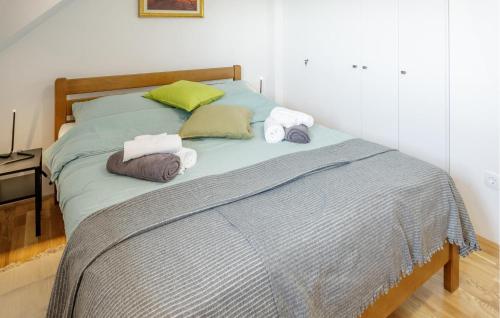 a bed with two towels and two pillows on it at Beautiful Home In Jastrebarsko in Jastrebarsko