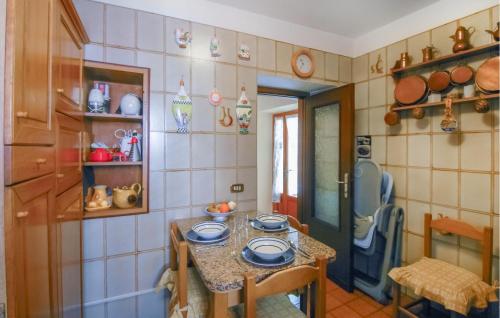 a kitchen with a small table with plates on it at Nice Home In Azzano With Wifi in Azzano