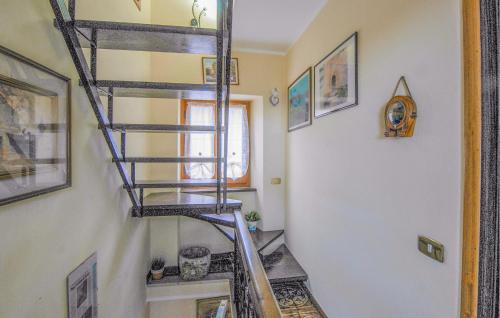 a spiral staircase in a room with a stair case at Nice Home In Azzano With Wifi in Azzano