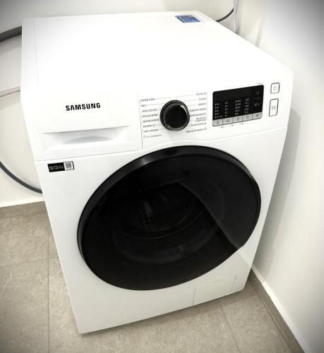 a white washing machine sitting in a room at Ophelia - luxury house in Ioppolo Giancaxio