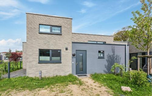 a brick house with a blue door at Awesome Home In Lembruchdümmer See in Lembruch