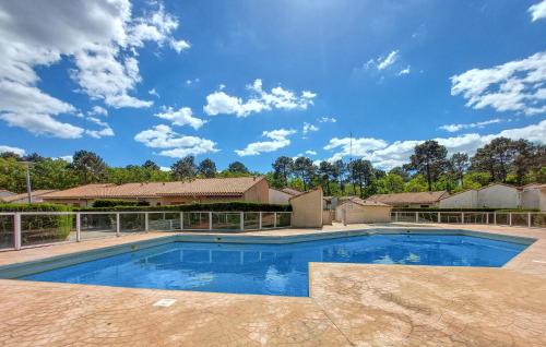 a swimming pool in a house with a blue sky at 2 Bedroom Beautiful Home In Les Mathes in Les Mathes