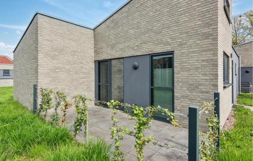 a brick house with a gray door at Gorgeous Home In Lembruchdümmer See in Lembruch