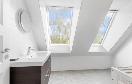 a white bathroom with a sink and a window at Beautiful Home In Humble With Wifi in Humble