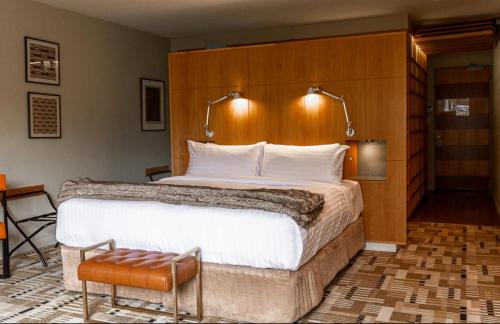 a bedroom with a large bed with a wooden headboard at Islington Hobart - Garden Suite - Australia in Hobart