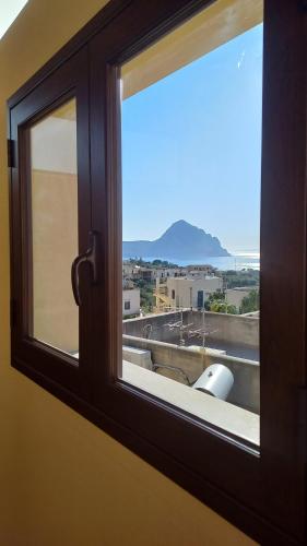 a window with a view of a city at Alykè Appartamenti Vacanze Macari in Macari