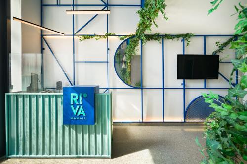 a building with a rx van sign on the wall at Riva Mamaia Beach Apart Hotel in Mamaia