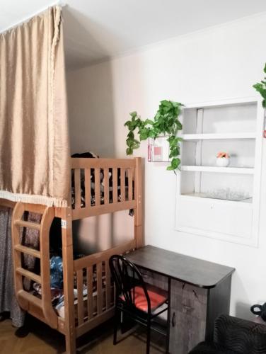 a room with a loft bed and a table at El Hostal in Tbilisi City