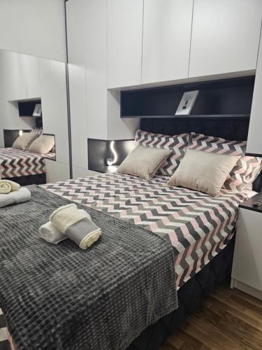 a bedroom with two beds with pillows on it at Apartman ALLURE - Bijeljina in Bijeljina
