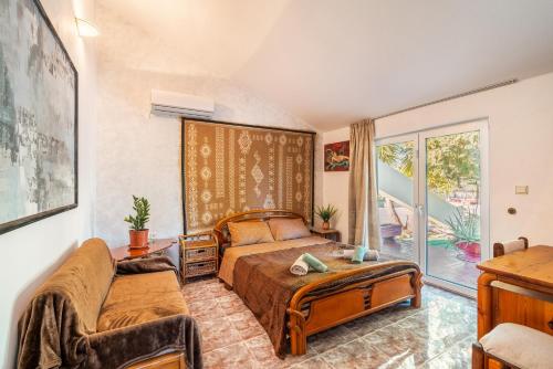 a bedroom with a bed and a couch at Artzy Villa in Rhodes Town