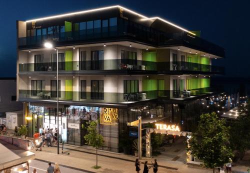 a building with green lights on top of it at Riva Mamaia Beach Apart Hotel in Mamaia