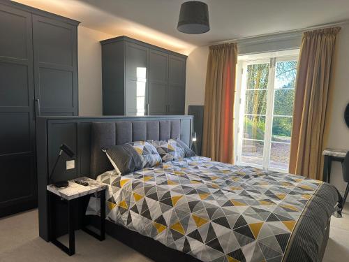 a bedroom with a large bed and a window at Glebe House in Sion Mills