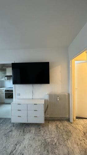 un salon avec une télévision à écran plat sur un mur dans l'établissement VIP 66 b, à Cannes