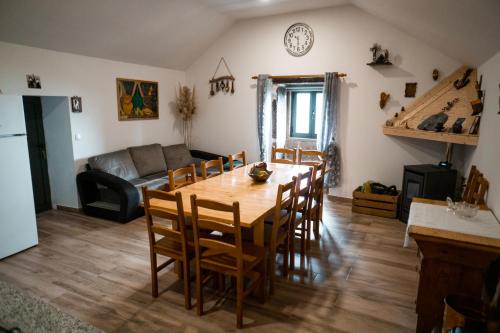 a kitchen and living room with a wooden table and chairs at Refúgio Nariz do Mundo (Casa do Meio) in Cabeceiras de Basto