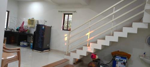 a staircase in a living room with a stair case at DESTINY VILLA in Panhāla