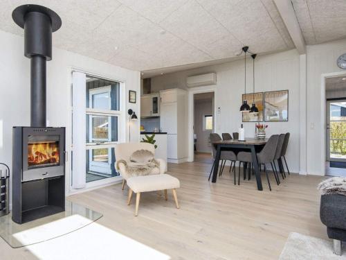 a living room with a fireplace and a dining room at 6 person holiday home in Lemvig in Lemvig