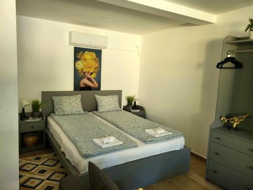 a bedroom with a bed and a painting on the wall at Dream Lake in Palić