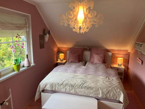 a bedroom with a bed and a chandelier at Sweet Little Home Mimi in Berlin