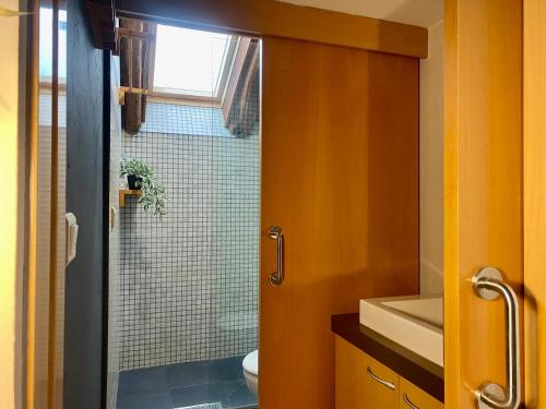 a bathroom with a shower with a glass door at loft de la place in Bourg-Madame