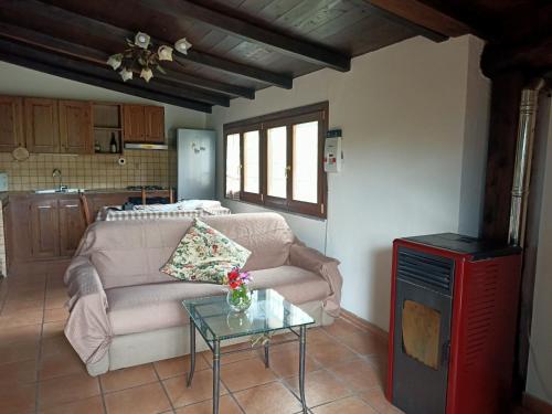a living room with a couch and a table at Casa Micuccio in Torrimpietra
