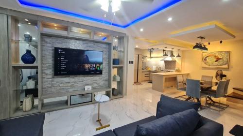uma sala de estar com uma grande televisão de ecrã plano em Casa Nayah em Cebu