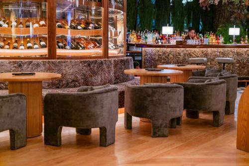 a restaurant with tables and chairs and a bar at Waldorf Astoria Doha West Bay in Doha