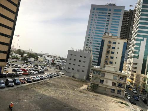 a parking lot with parked cars in a city at Al Majaz Partition & Rooms in Sharjah