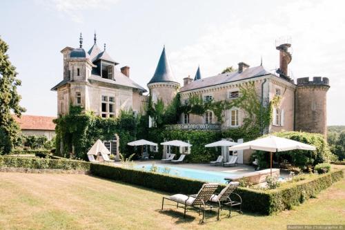 a large castle with a swimming pool in front of it at Saint Victor La Grand' Maison in Ingrandes