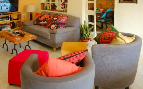 a living room with two chairs and a couch at Bellavista 3 Bedroom Apartment in Marsaskala
