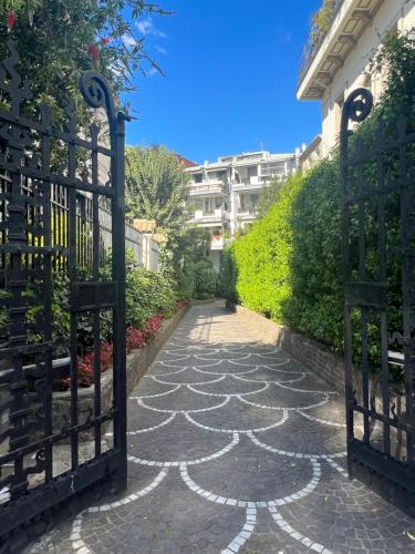 a gate to a walkway in front of a building at Villa Borghese Green Apartment in Rome