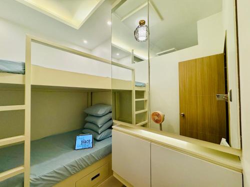 a small bedroom with bunk beds and a mirror at SMDC Vine Residences Condo in Manila
