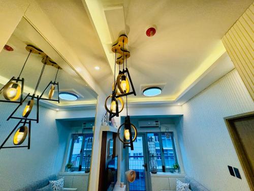 a room with lights hanging from a ceiling at SMDC Vine Residences Condo in Manila