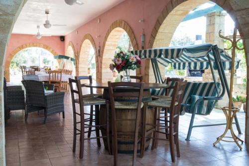 a restaurant with arches and tables and chairs at I SOGNI DI VENERE in Torre Suda