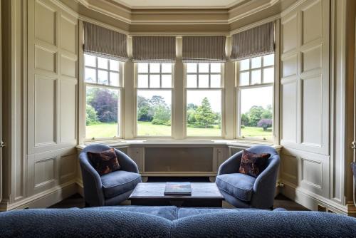 a living room with two chairs and a large window at Isle of Eriska Hotel Spa & Island in Benderloch