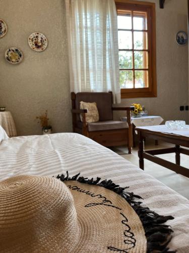 a bedroom with a bed with a hat on it at Rustic and Spacious House in Mytilinioí
