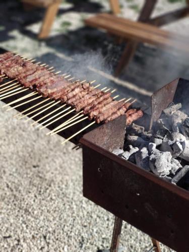 a grill with a bunch of meat on it at Casa Felix in Giulianova