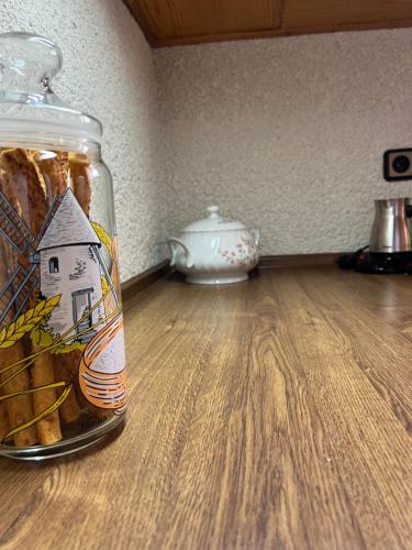 a jar of food sitting on a wooden floor at Rustic and Spacious House in Mytilinioí