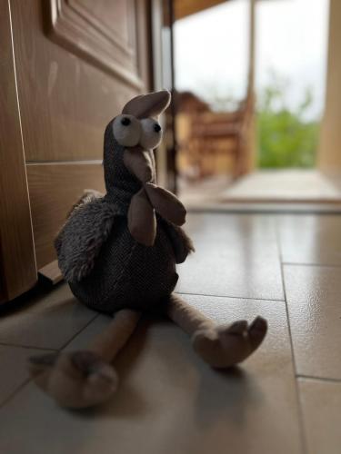 a stuffed rabbit sitting on the floor in a kitchen at Rustic and Spacious House in Mytilinioí