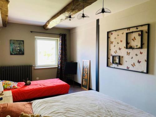 a bedroom with two beds and a window at Crisoline in Longwy-sur-le-Doubs