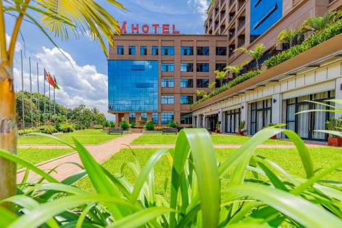 a view of the hotel from the grass at M Hotel Kigali in Kigali