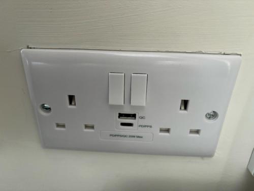 a white light switch on a white wall at Stansted Coach House - Apartment Hotel in Elsenham
