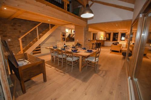 une grande salle à manger avec une table et des chaises dans l'établissement Maison du Bûcheron, à Vacheresse