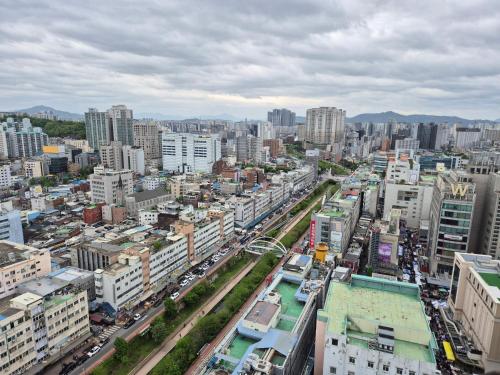 a city with buildings and cars in a city at "GRAND OPENED" Maxtyle Guesthouse Dongdaemun in Seoul