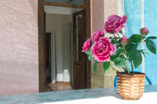 a vase filled with pink roses sitting on a table at I SOGNI DI VENERE in Torre Suda