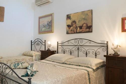 a bedroom with two beds and two pictures on the wall at I SOGNI DI VENERE in Torre Suda