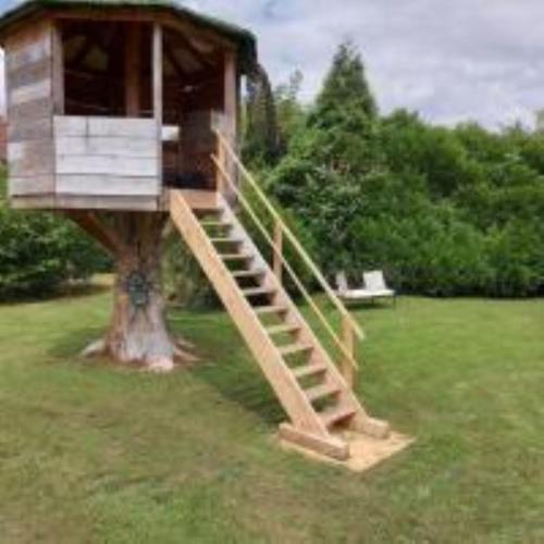 a tree house sitting on a tree at Crisoline in Longwy-sur-le-Doubs