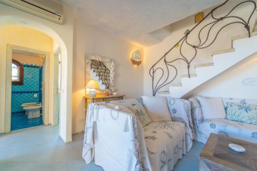 a living room with a couch and a staircase at Villa Ilda in Cannigione